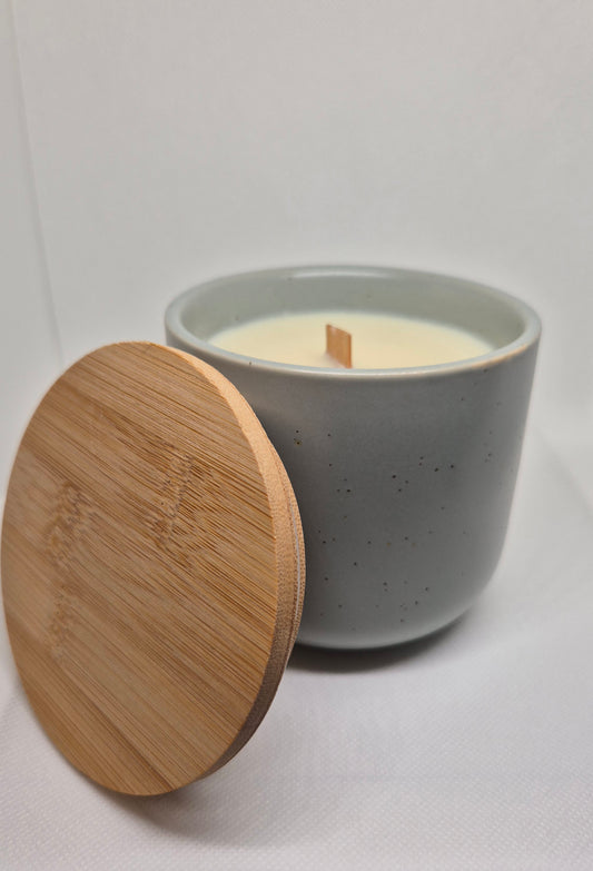 Candle in a ceramic container with wooden lid